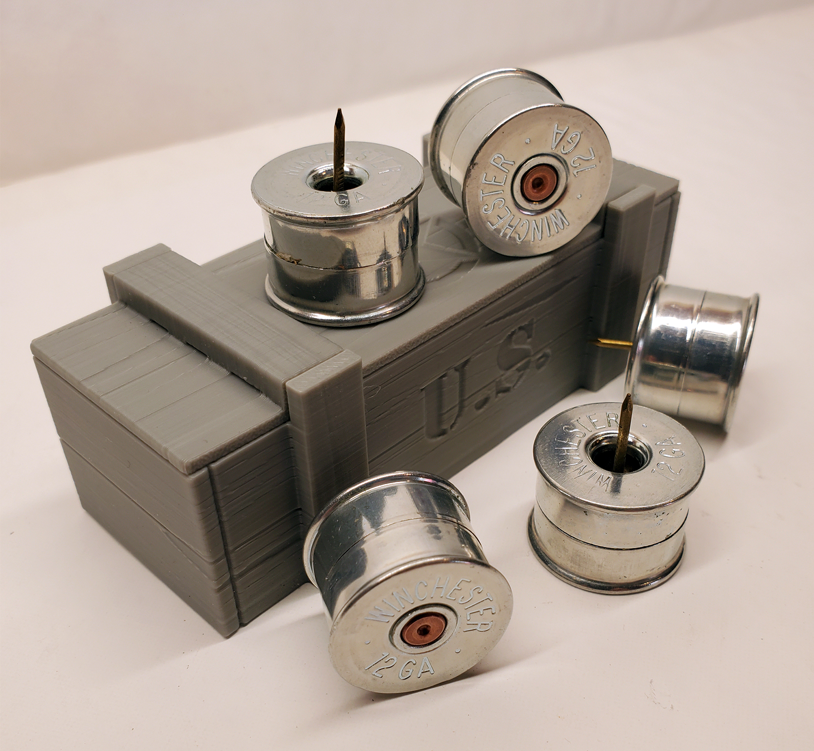 Five awesome push pins made from a once fired 12 gauge nickel shotgun shells