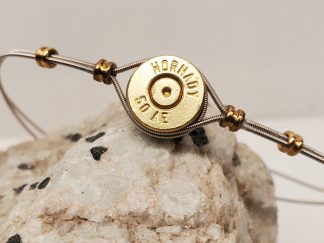 50 AE Bullet Casings and Guitar Strings Unisex Bracelet on rock close up